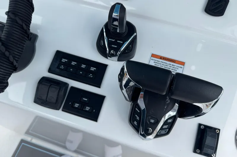 Slide: The Image of Control panel of 2024 Contender 30 Tournament boat with throttle and switches. - 14