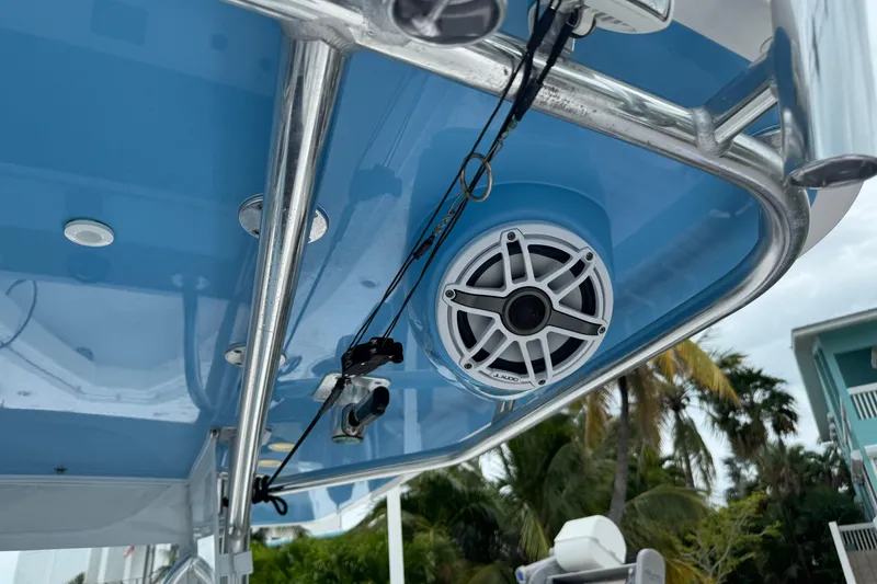 Slide: The Image of 2024 Contender 30 Tournament boat with blue canopy and mounted speaker system. - 21