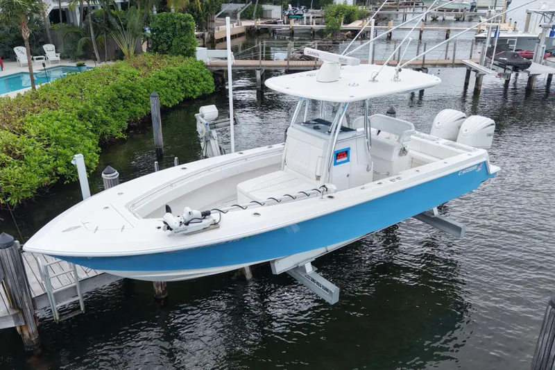 Slide: The Image of 2024 Contender 30 Tournament boat docked, featuring sleek design and dual engines. - 3