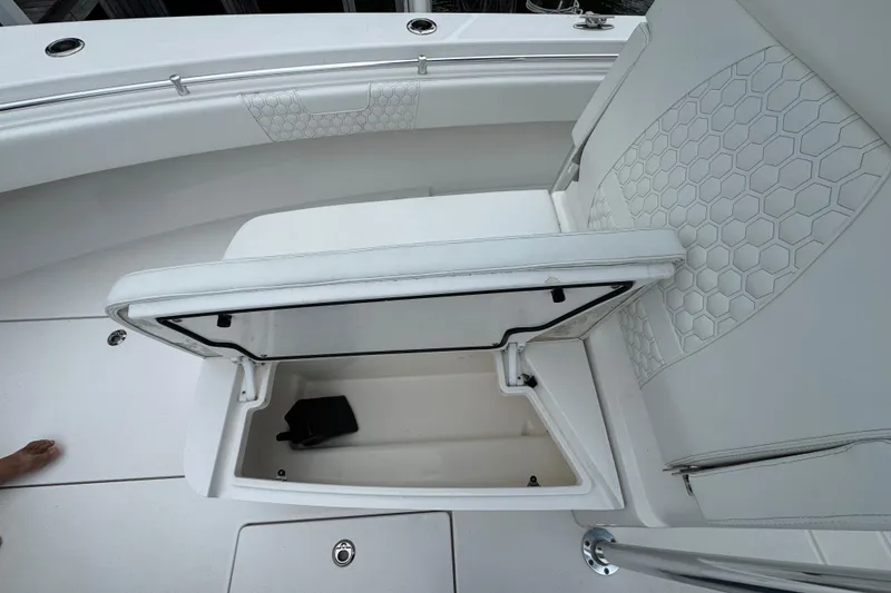 Slide: The Image of 2024 Contender 30 Tournament boat with open storage compartment and hexagonal seat pattern. - 32