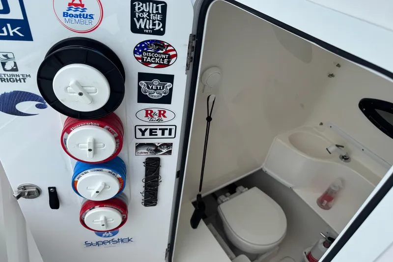 Slide: The Image of 2024 Contender 30 Tournament boat interior with fishing gear and restroom. - 35