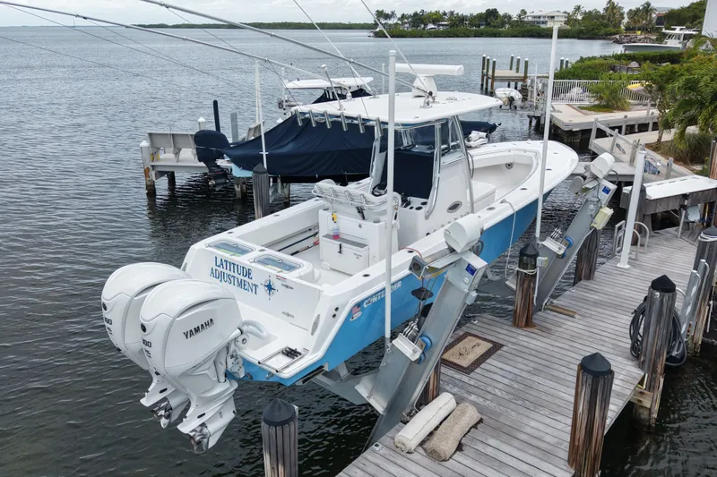 Slide: The Image of 2024 Contender 30 Tournament boat docked with dual Yamaha engines. - 5