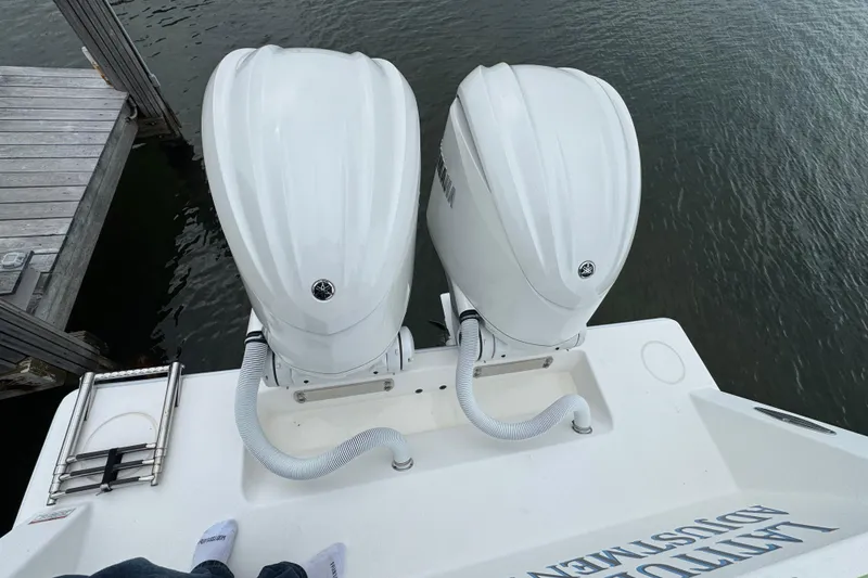 Slide: The Image of 2024 Contender 30 Tournament boat with dual outboard engines at dockside. - 8