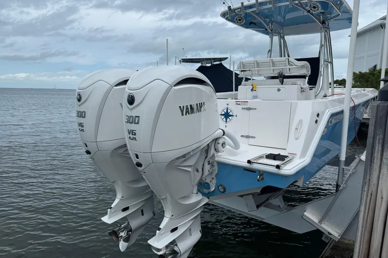 Slide: The Image of 2024 Contender 30 Tournament boat with twin Yamaha 300 V6 outboard engines docked by the water. - 9