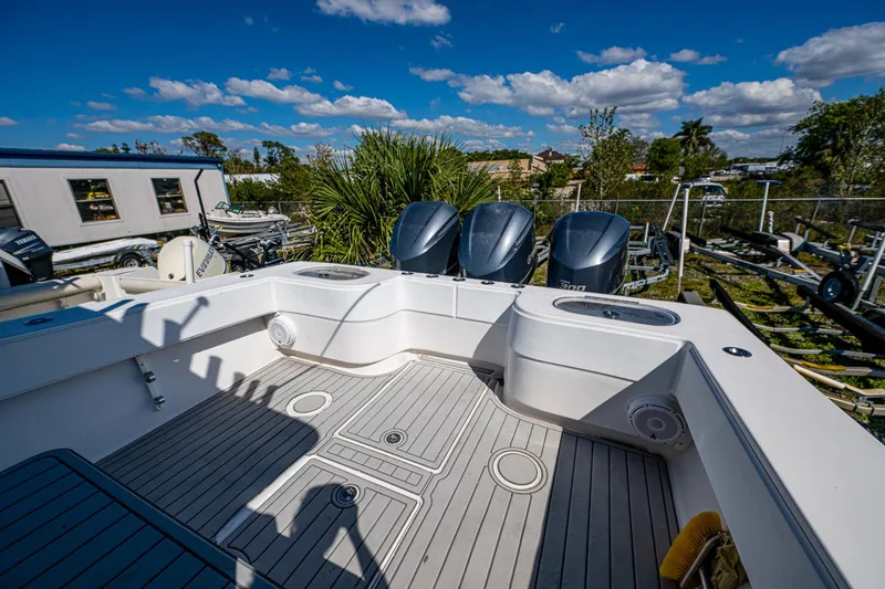 Slide: The Image of 2015 SeaHunter 37 Tournament boat with triple outboard engines, spacious deck, and clear skies. - 10