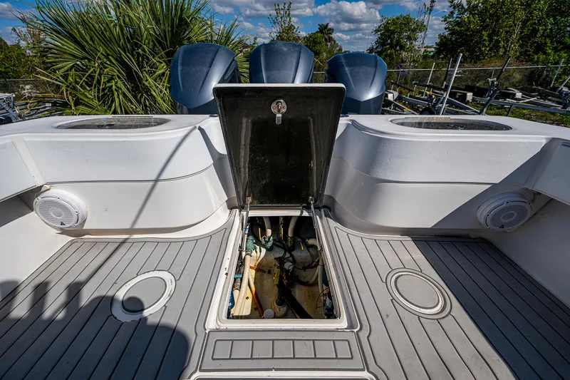 Slide: The Image of 2015 SeaHunter 37 Tournament boat deck with open hatch, showcasing storage and engine access. - 11