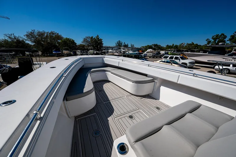 Slide: The Image of 2015 SeaHunter 37 Tournament boat deck with seating, parked outdoors under clear blue sky. - 13