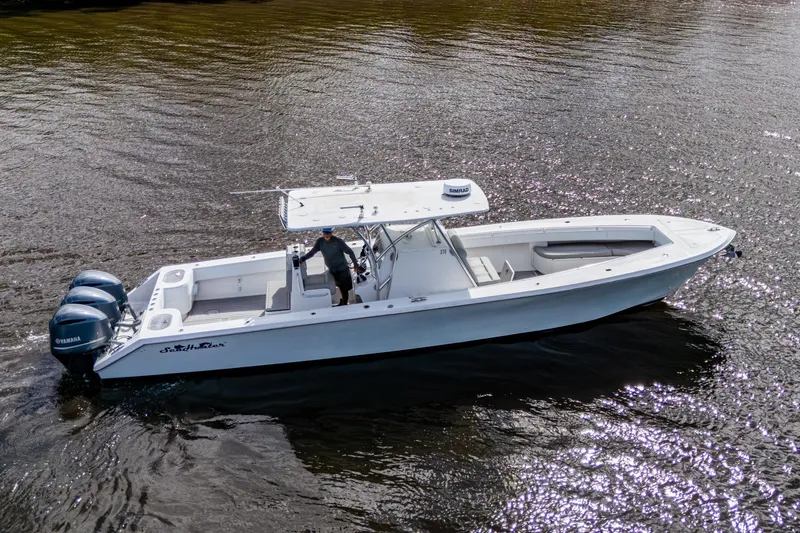 Slide: The Image of 2015 SeaHunter 37 Tournament boat on water with triple Yamaha engines. - 18