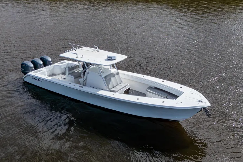 Slide: The Image of 2015 SeaHunter 37 Tournament boat with triple outboard engines on calm water. - 22