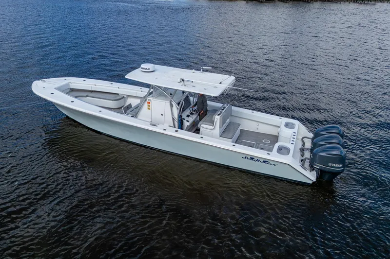 Slide: The Image of 2015 SeaHunter 37 Tournament boat with triple Yamaha engines on open water. - 29