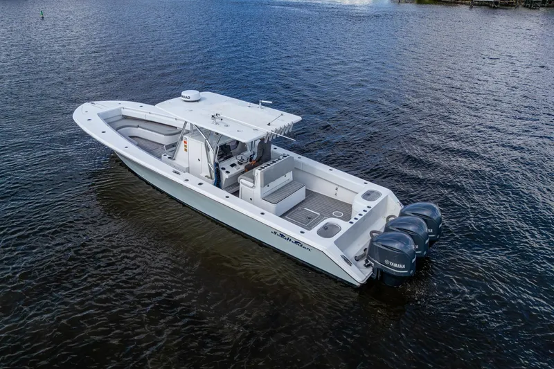 Slide: The Image of 2015 SeaHunter 37 Tournament boat with triple Yamaha engines on open water. - 30