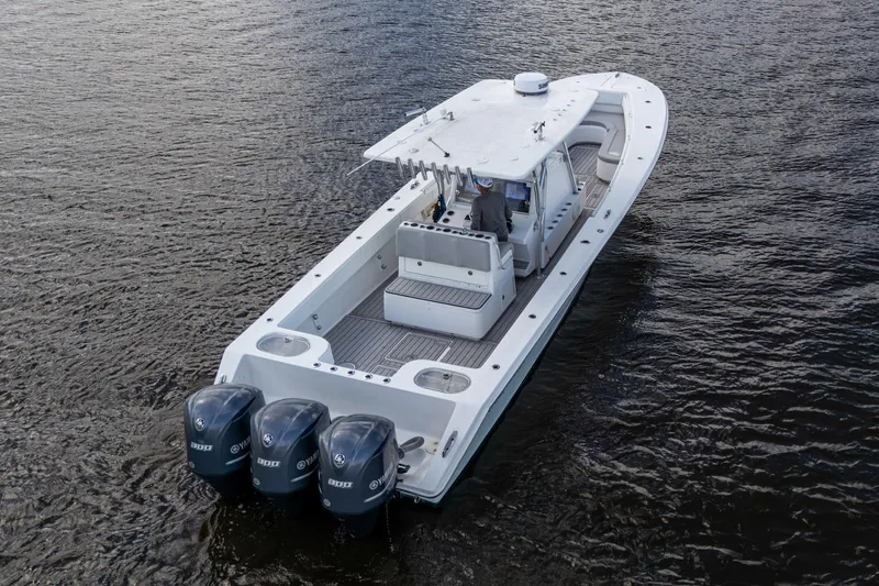 Slide: The Image of 2015 SeaHunter 37 Tournament boat with triple outboard engines on open water. - 32