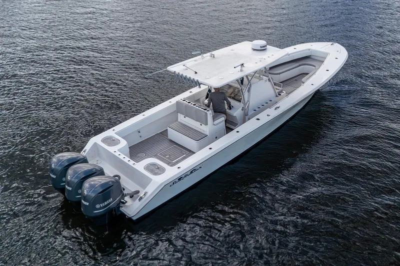 Slide: The Image of 2015 SeaHunter 37 Tournament boat with triple Yamaha engines on open water. - 33