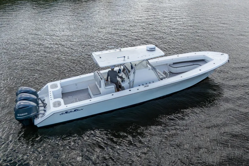 Slide: The Image of 2015 SeaHunter 37 Tournament boat on water, featuring triple Yamaha engines. - 34