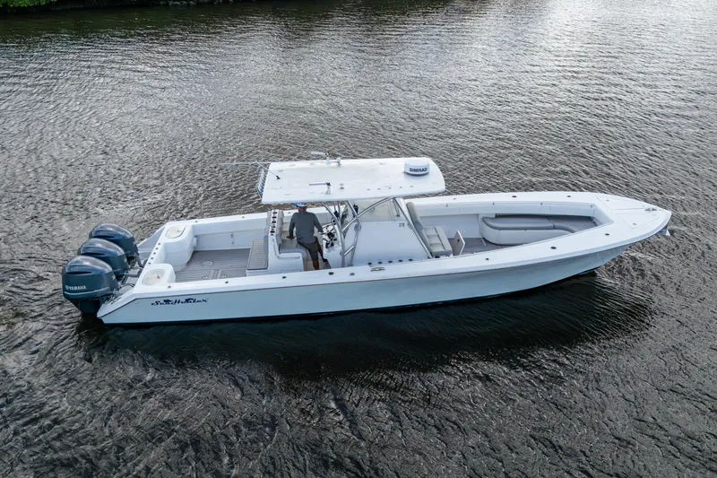 Slide: The Image of 2015 SeaHunter 37 Tournament boat on water, featuring triple Yamaha engines. - 35
