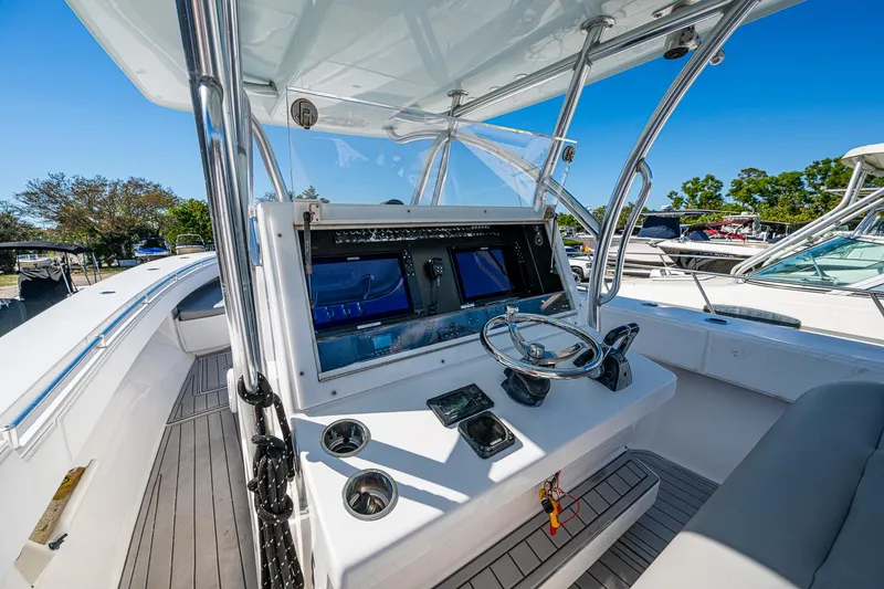 Slide: The Image of 2015 SeaHunter 37 Tournament boat cockpit with steering wheel and navigation screens. - 5