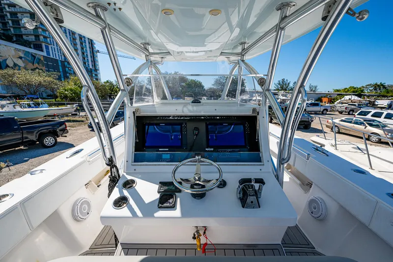 Slide: The Image of 2015 SeaHunter 37 Tournament boat cockpit with dual screens and steering wheel. - 6