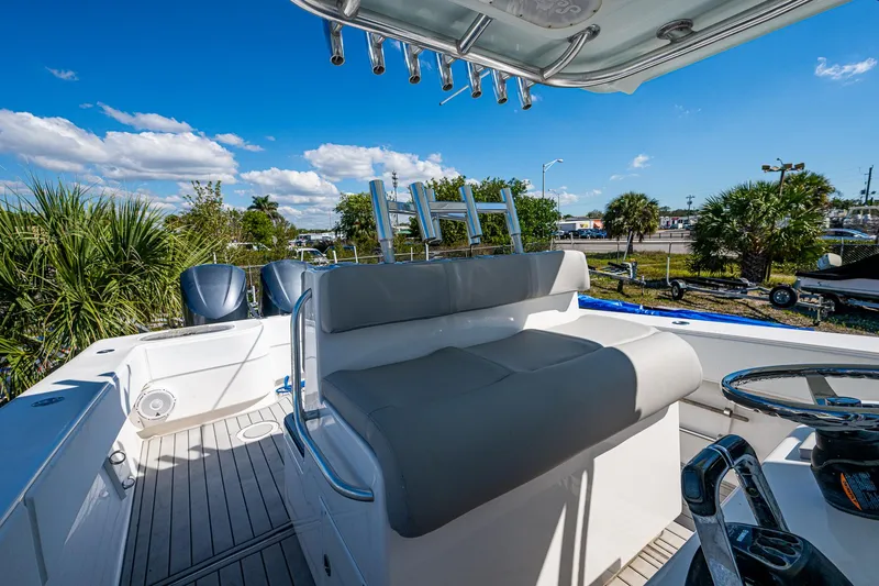 Slide: The Image of 2015 SeaHunter 37 Tournament boat interior with seating and steering wheel, under a clear blue sky. - 8