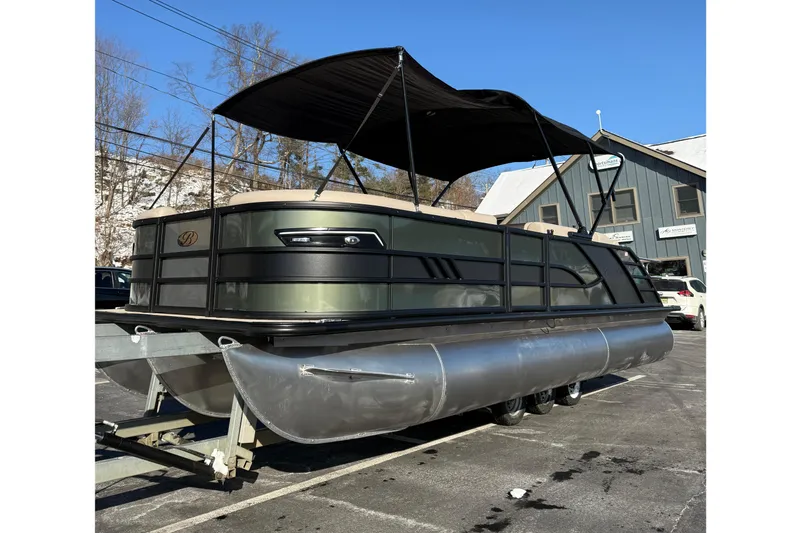 Slide: The Image of 2026 Bentley Pontoons Elite 223 Swingback Bench on trailer under clear blue sky. - 0