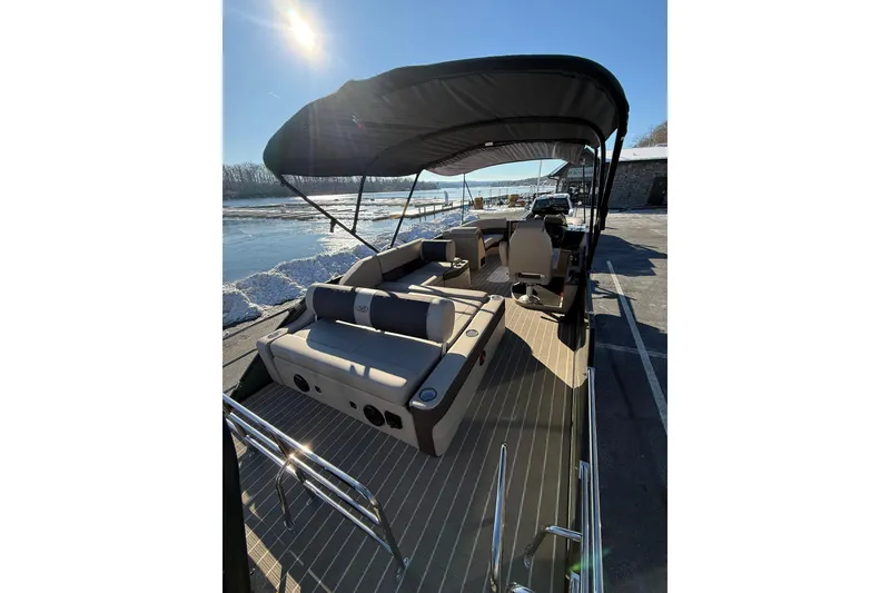 Slide: The Image of 2026 Bentley Pontoons Elite 223 Swingback Bench on sunny waterfront. - 5