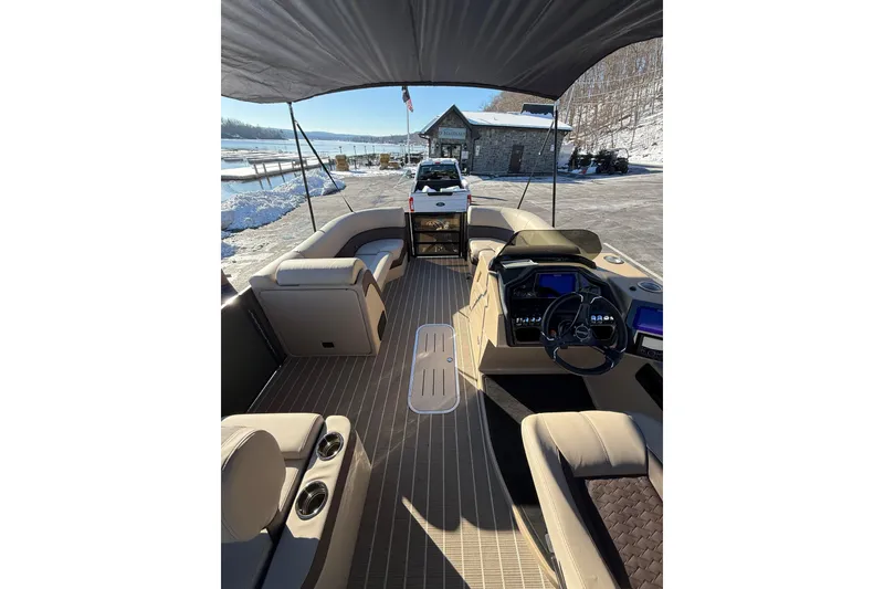 Slide: The Image of 2026 Bentley Pontoons Elite 223 Swingback Bench interior with luxurious seating and modern dashboard. - 8