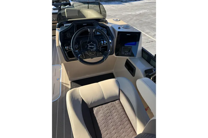 Slide: The Image of Interior of 2026 Bentley Pontoons Elite 223 Swingback Bench, featuring steering wheel and dashboard. - 9
