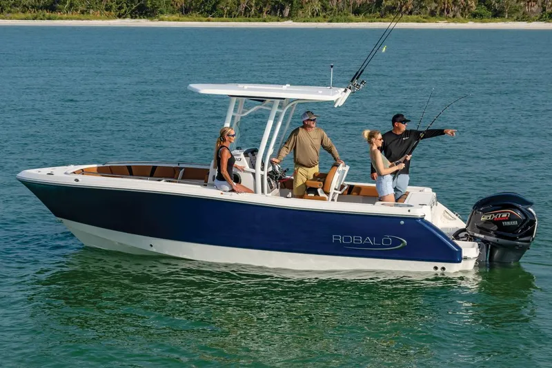 Slide: The Image of Manufacturer Provided Image: 2025 Robalo R230 Center Console boat with people fishing on calm water. - 1