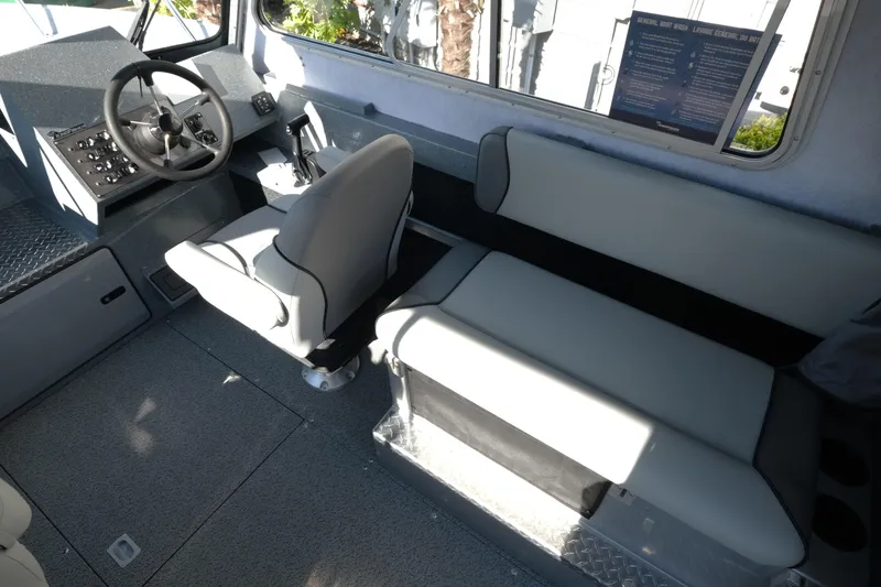 Slide: The Image of Interior of 2026 KingFisher 2425 Escape HT boat, featuring steering wheel and seating. - 12