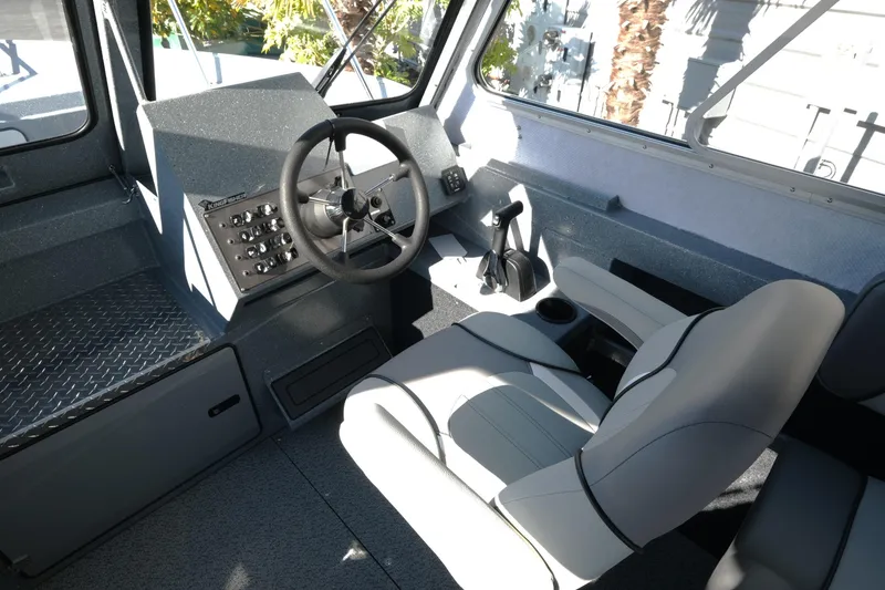 Slide: The Image of Interior of 2026 KingFisher 2425 Escape HT boat with steering wheel and seating. - 13