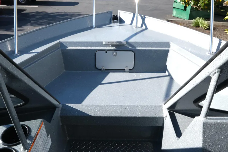 Slide: The Image of 2026 KingFisher 2425 Escape HT boat interior with storage compartment and cup holders. - 16