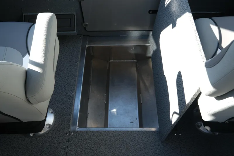 Slide: The Image of 2026 KingFisher 2425 Escape HT boat interior storage compartment between seats. - 18