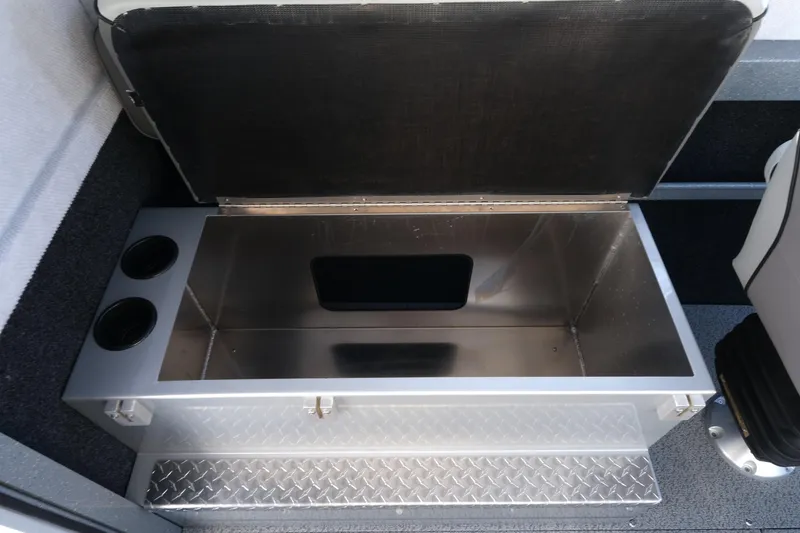 Slide: The Image of Open storage compartment in 2026 KingFisher 2425 Escape HT boat, featuring diamond plate flooring. - 19