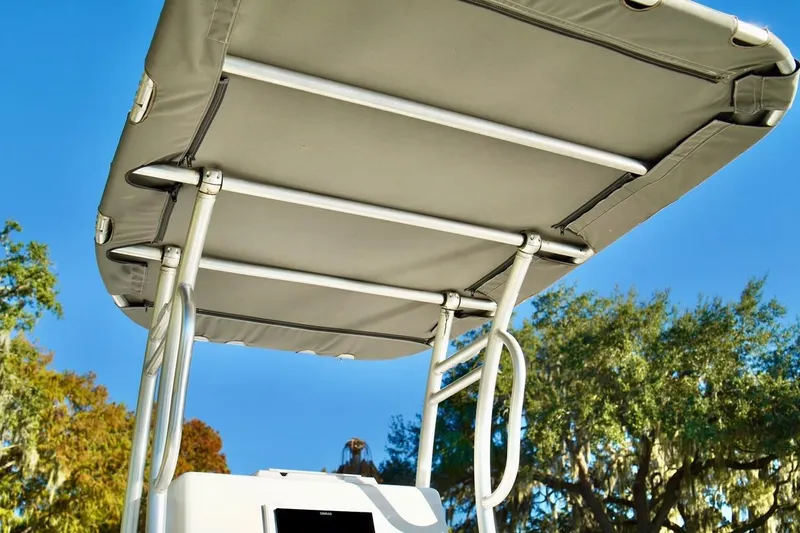 Slide: The Image of 1970 Aquasport 222 Flatback boat canopy against a clear blue sky. - 13