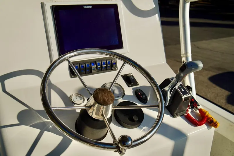 Slide: The Image of 1970 Aquasport 222 Flatback boat dashboard with steering wheel and controls. - 15