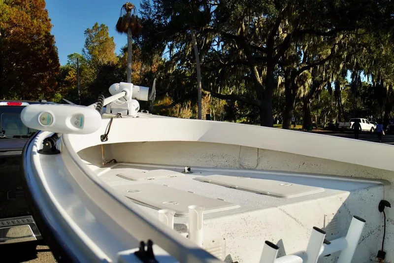 Slide: The Image of 1970 Aquasport 222 Flatback boat on trailer, surrounded by trees and parked vehicles. - 5