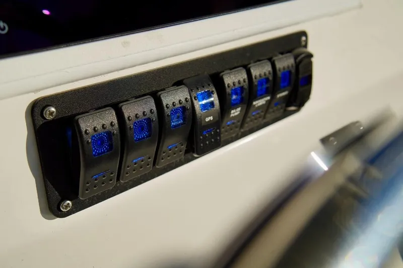 Slide: The Image of Control panel with illuminated switches on a 1970 Aquasport 222 Flatback boat. - 16