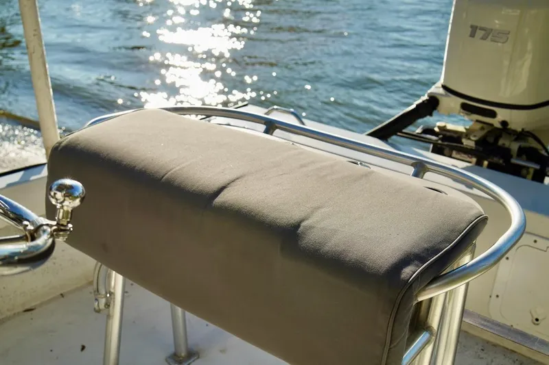 Slide: The Image of 1970 Aquasport 222 Flatback boat seat with railing, overlooking sparkling water. - 22