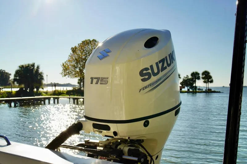 Slide: The Image of 1970 Aquasport 222 Flatback with Suzuki 175 outboard motor on a sunny lake. - 23