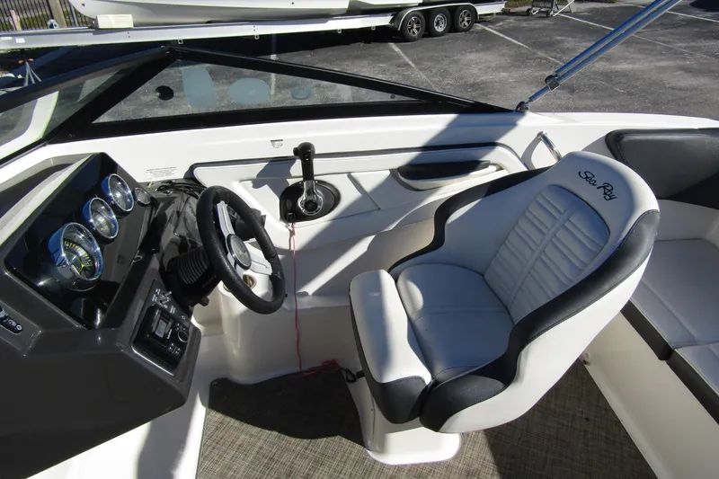 Slide: The Image of 2018 Sea Ray SPX 190 Outboard boat interior with steering wheel and captain's seat. - 10