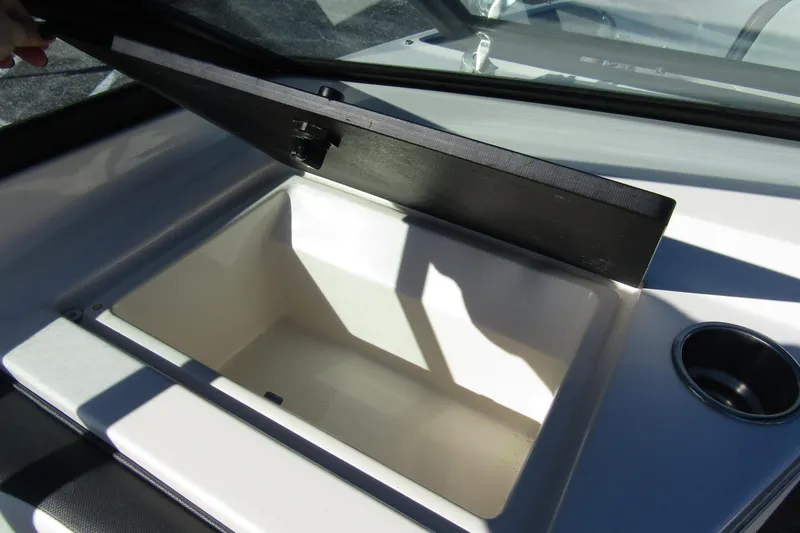 Slide: The Image of 2018 Sea Ray SPX 190 Outboard storage compartment with open lid and cup holder. - 17