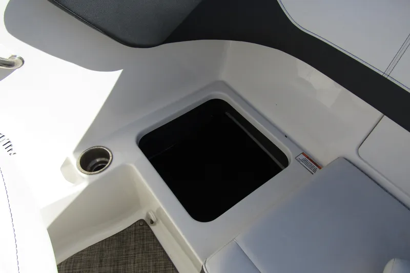 Slide: The Image of 2018 Sea Ray SPX 190 Outboard boat interior storage compartment with cup holder. - 22