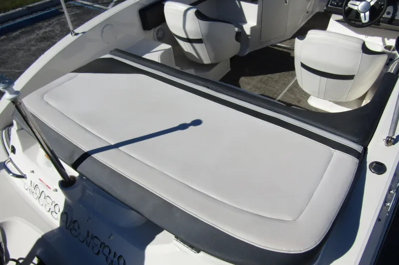 Slide: The Image of 2018 Sea Ray SPX 190 Outboard boat interior with white seating and steering wheel. - 25