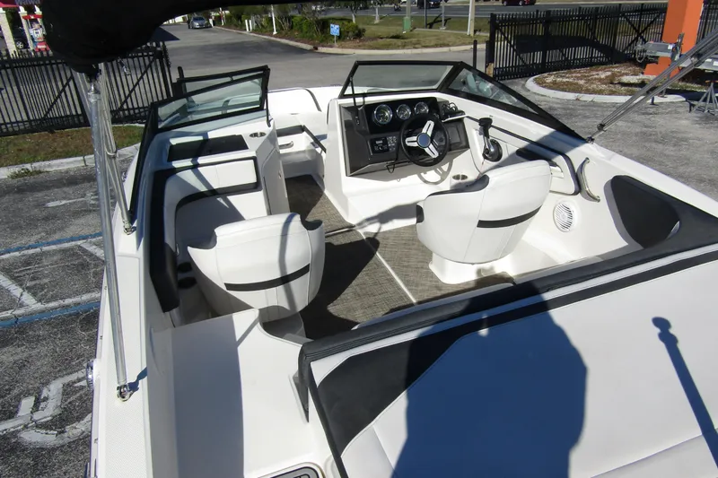 Slide: The Image of 2018 Sea Ray SPX 190 Outboard boat interior with white seating and steering console. - 29