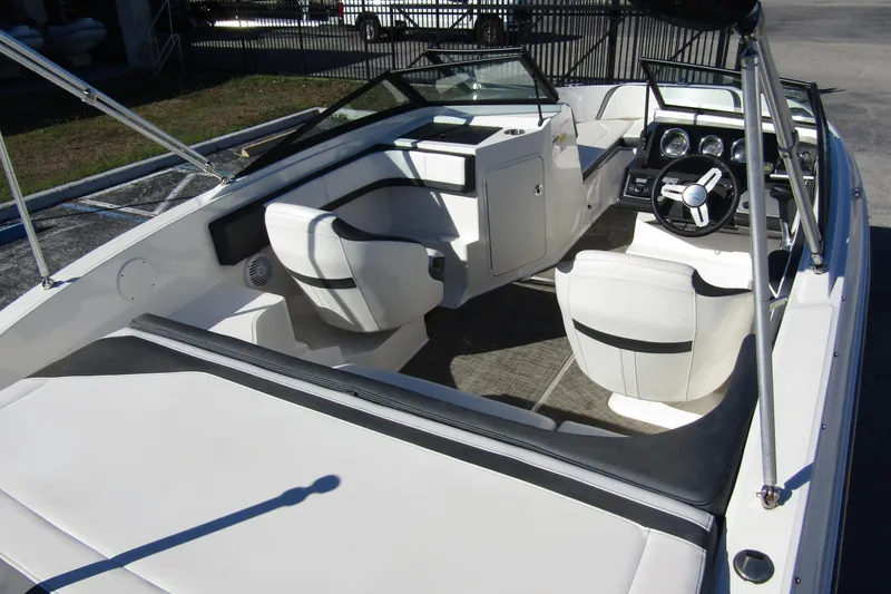 Slide: The Image of 2018 Sea Ray SPX 190 Outboard boat interior with white seating and steering console. - 30
