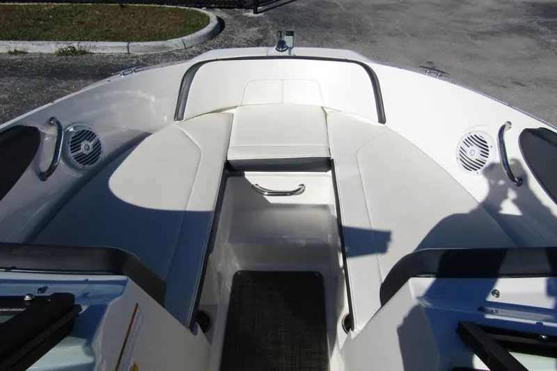 Slide: The Image of 2018 Sea Ray SPX 190 Outboard boat interior with white seating and speakers. - 6