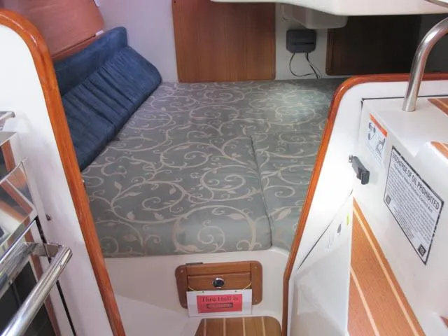 Slide: The Image of Interior of a 2000 Catalina 310 yacht with cozy sleeping area. - 16