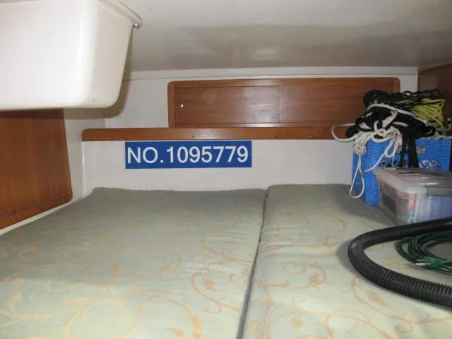 Slide: The Image of Interior of a 2000 Catalina 310 yacht with storage and mattress. - 17