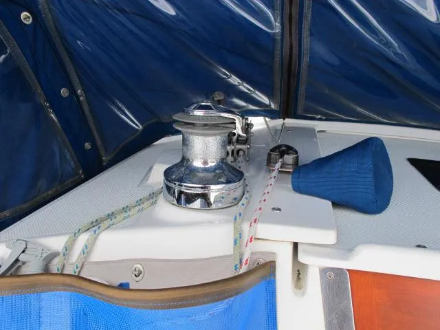 Slide: The Image of Deck view of a 2000 Catalina 310 yacht with blue cover. - 26