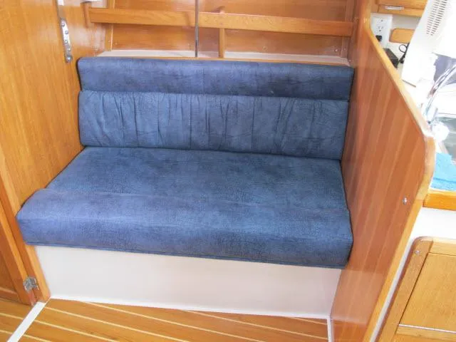 Slide: The Image of Interior of a 2000 Catalina 310 yacht with blue upholstered bench. - 4