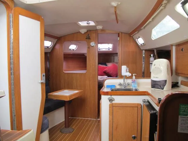Slide: The Image of Interior of a 2000 Catalina 310 yacht with wooden furnishings. - 7